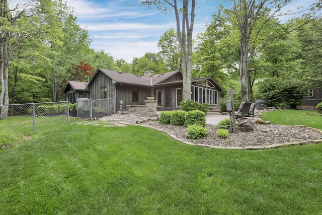 13115 Jack Run Rd, Rockbridge, OH 43149 - rear view of property with board and batten siding, a patio area, a chimney, a sunroom, and a gate