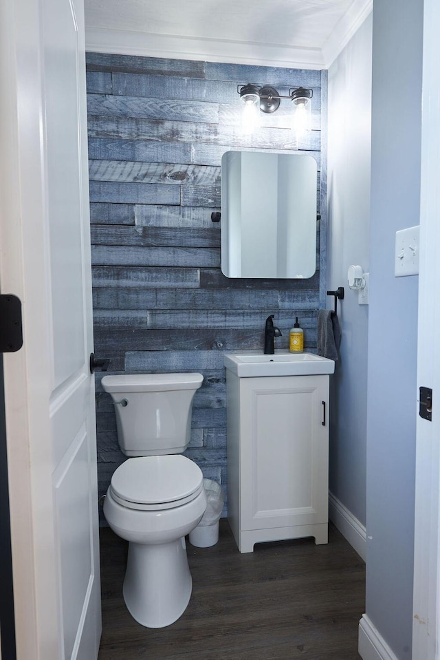 258 E Welch Ave, Columbus, OH 43207 - half bathroom with vanity, wood finished floors, toilet, and baseboards