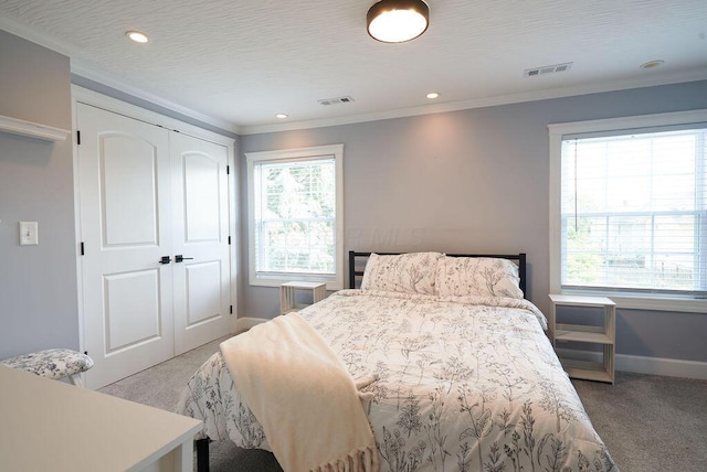 258 E Welch Ave, Columbus, OH 43207 - bedroom featuring light colored carpet, crown molding, baseboards, recessed lighting, and a closet