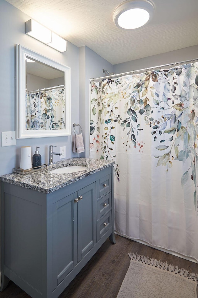 258 E Welch Ave, Columbus, OH 43207 - full bathroom featuring wood finished floors, vanity, and curtained shower