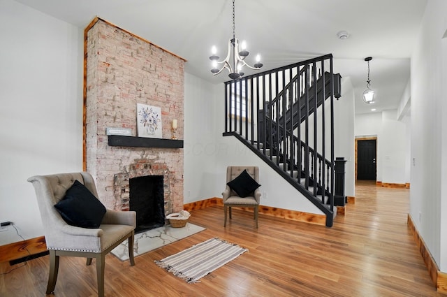 525 Saint Clair Ave, Columbus, OH 43203 - living room featuring a chandelier, wood finished floors, baseboards, and stairs