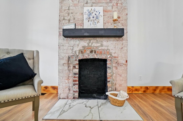 525 Saint Clair Ave, Columbus, OH 43203 - detailed view of wood finished floors, a fireplace with flush hearth, and baseboards