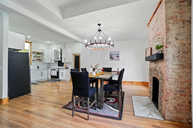 525 Saint Clair Ave, Columbus, OH 43203 - dining area featuring a chandelier, light wood-style flooring, and baseboards