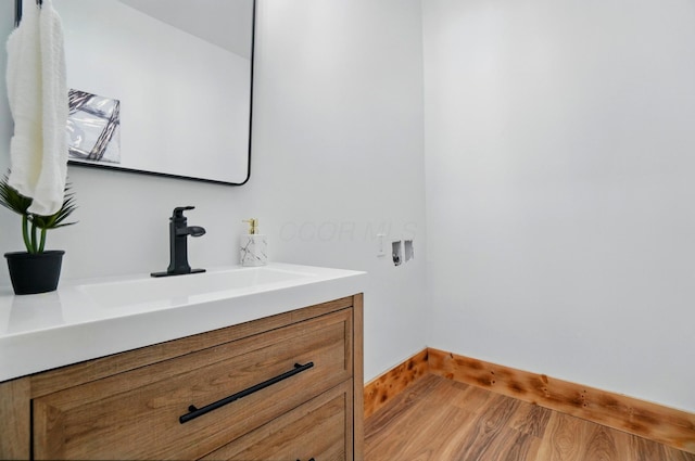 525 Saint Clair Ave, Columbus, OH 43203 - bathroom featuring vanity, baseboards, and wood finished floors