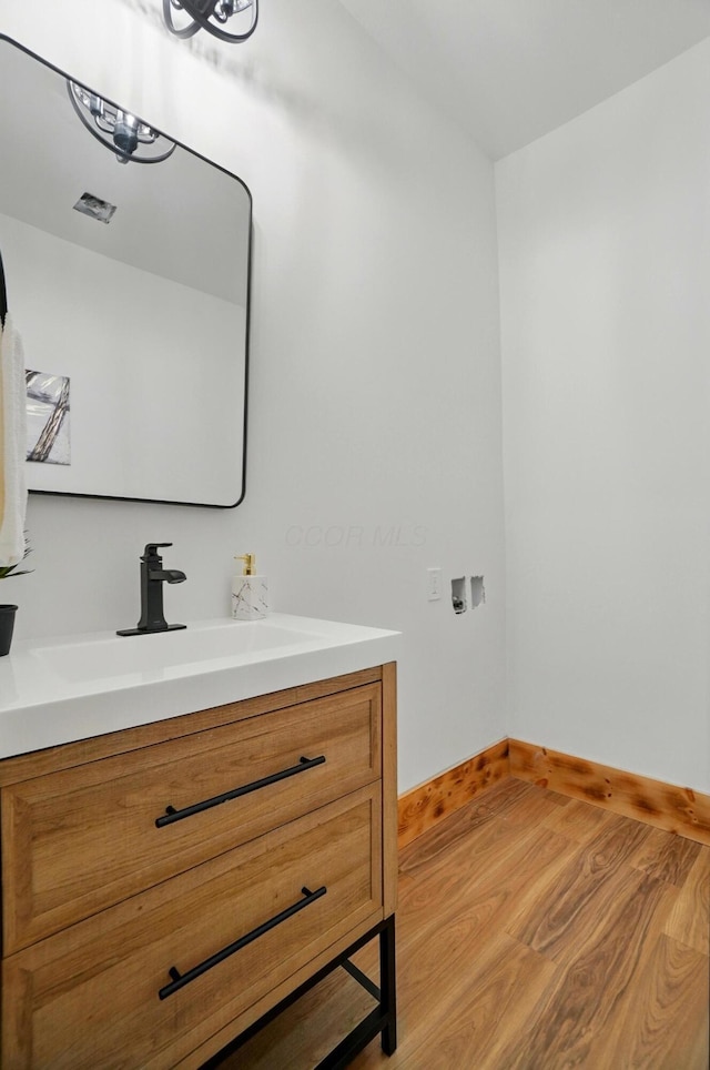 525 Saint Clair Ave, Columbus, OH 43203 - bathroom with vanity, baseboards, and wood finished floors