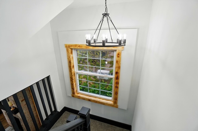 525 Saint Clair Ave, Columbus, OH 43203 - stairway with a chandelier and baseboards