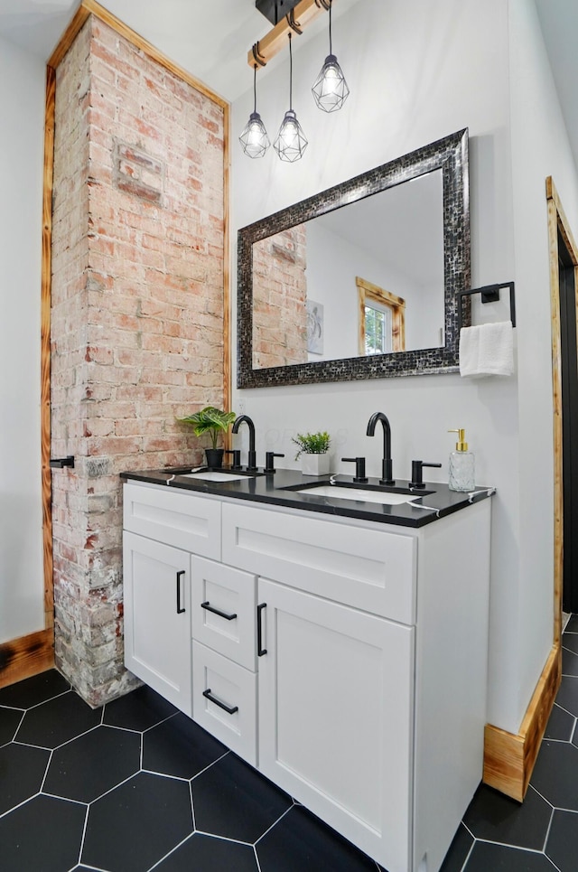 525 Saint Clair Ave, Columbus, OH 43203 - bathroom with double vanity, tile patterned floors, and brick wall