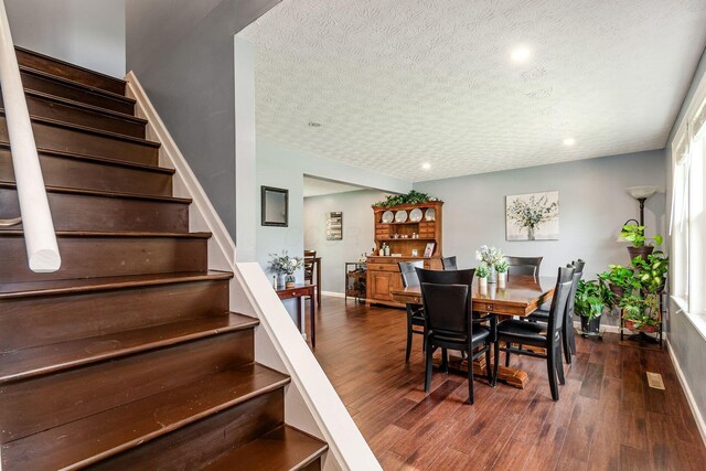 6407 Skywae Dr, Columbus, OH 43229 - dining room with stairway, baseboards, wood finished floors, a textured ceiling, and recessed lighting
