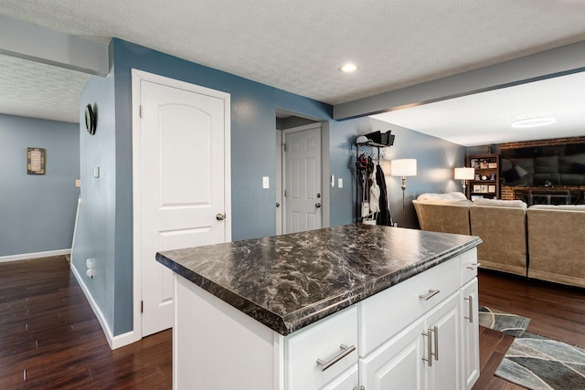 6407 Skywae Dr, Columbus, OH 43229 - kitchen featuring dark wood finished floors, dark countertops, baseboards, a textured ceiling, and recessed lighting