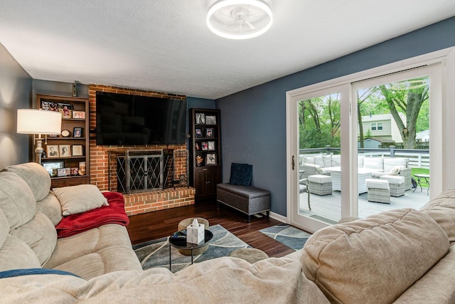 6407 Skywae Dr, Columbus, OH 43229 - living room with wood finished floors, a brick fireplace, and baseboards