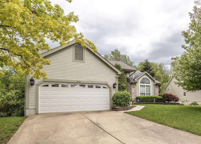 7711 Eagle Creek Dr, Pickerington, OH 43147 - ranch-style house featuring concrete driveway, a front yard, and a garage