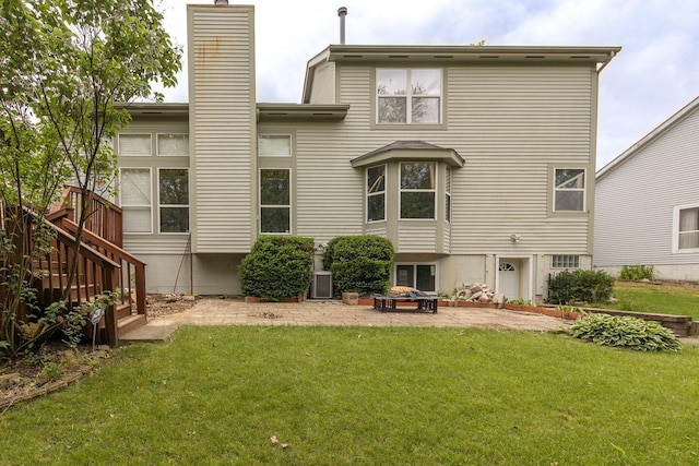 7711 Eagle Creek Dr, Pickerington, OH 43147 - rear view of house with a chimney, a patio area, and a yard