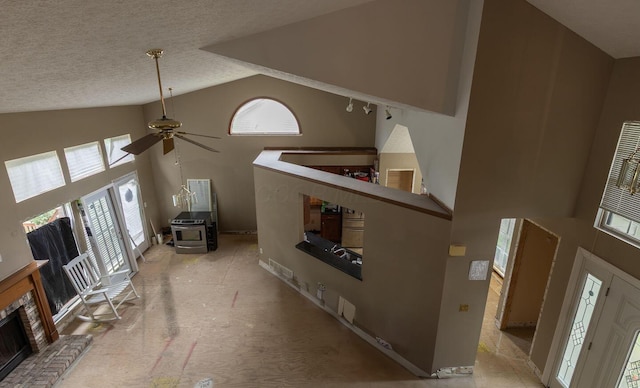 7711 Eagle Creek Dr, Pickerington, OH 43147 - unfurnished living room featuring a ceiling fan, high vaulted ceiling, a textured ceiling, and a brick fireplace