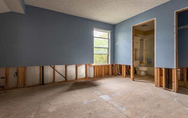 7711 Eagle Creek Dr, Pickerington, OH 43147 - unfurnished bedroom with connected bathroom and a textured ceiling