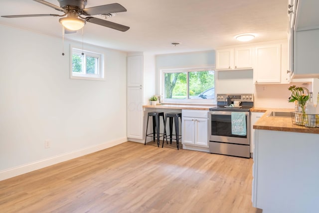 2535 Gooding Rd, Marion, OH 43302 - kitchen with stainless steel electric range, plenty of natural light, light wood-type flooring, and white cabinets