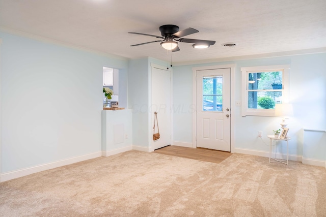 2535 Gooding Rd, Marion, OH 43302 - entryway with light colored carpet, a ceiling fan, baseboards, and ornamental molding