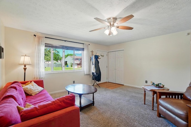 3784 Hendron Rd, Groveport, OH 43125 - living room with carpet, a ceiling fan, baseboards, and a textured ceiling