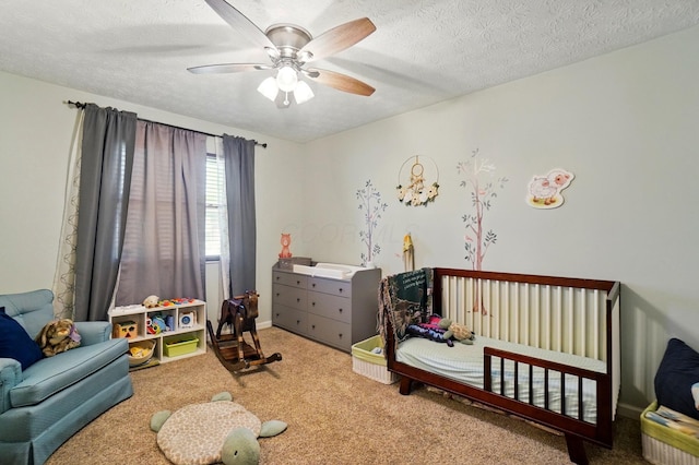 3784 Hendron Rd, Groveport, OH 43125 - carpeted bedroom featuring a crib, a textured ceiling, and ceiling fan