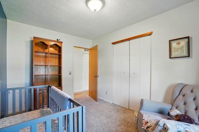 3784 Hendron Rd, Groveport, OH 43125 - bedroom with light colored carpet, a closet, a textured ceiling, and baseboards