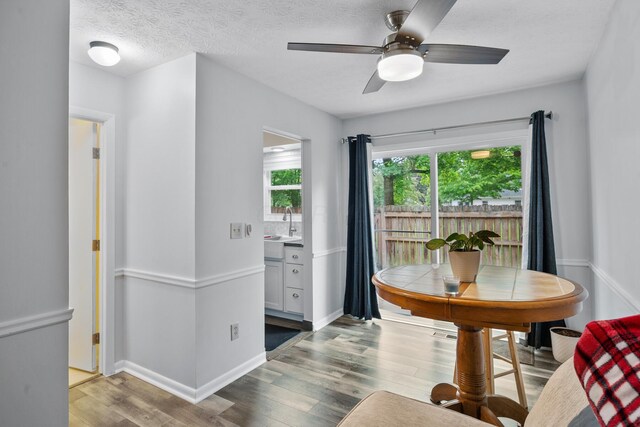 566 Harding Ln, Delaware, OH 43015 - dining room with wood finished floors, ceiling fan, baseboards, and a textured ceiling