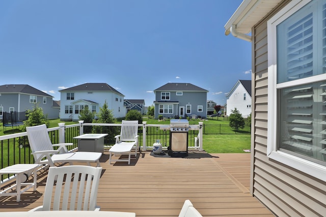 12349 Ebright Ln, Pickerington, OH 43147 - wooden deck with a residential view, a yard, a trampoline, and a grill