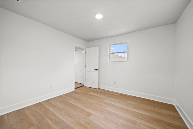 1006 Midland Ave, Columbus, OH 43223 - spare room featuring baseboards, light wood finished floors, and recessed lighting