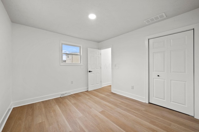 1006 Midland Ave, Columbus, OH 43223 - unfurnished bedroom with baseboards, light wood-type flooring, and a closet