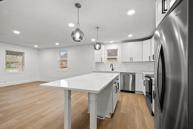 1006 Midland Ave, Columbus, OH 43223 - kitchen with appliances with stainless steel finishes, plenty of natural light, a breakfast bar, decorative backsplash, and recessed lighting