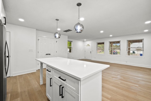 1006 Midland Ave, Columbus, OH 43223 - kitchen with stainless steel fridge with ice dispenser, recessed lighting, light wood finished floors, baseboards, and a kitchen island