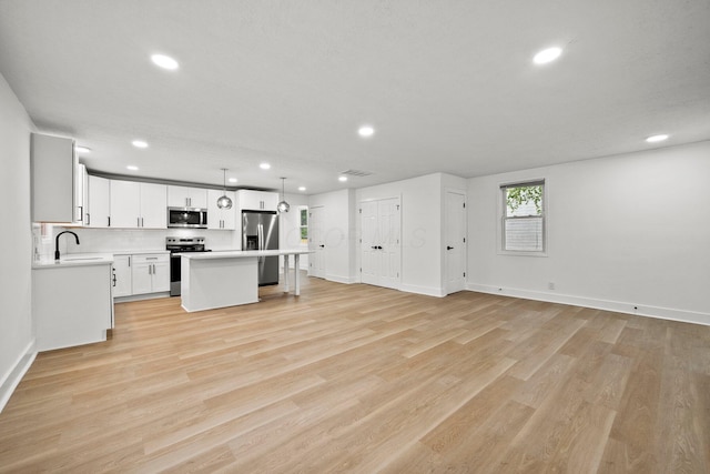 1006 Midland Ave, Columbus, OH 43223 - kitchen with appliances with stainless steel finishes, recessed lighting, a center island, light countertops, and open floor plan