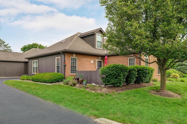 2539 Trotterslane Dr, Columbus, OH 43235 - view of property exterior with brick siding, a lawn, and a shingled roof