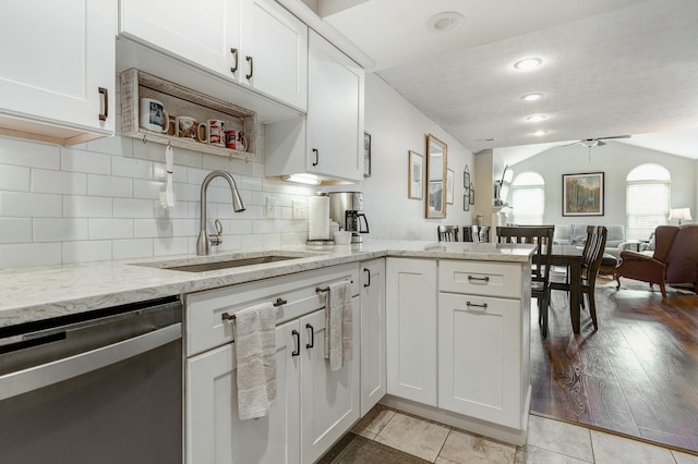 2539 Trotterslane Dr, Columbus, OH 43235 - kitchen featuring stainless steel dishwasher, a sink, a peninsula, white cabinetry, and open floor plan