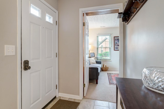 2539 Trotterslane Dr, Columbus, OH 43235 - entryway featuring baseboards, a textured ceiling, and light tile patterned flooring