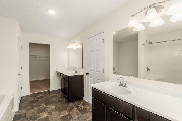 3339 Lauren Fields Dr S, Groveport, OH 43125 - bathroom with a tub, two vanities, a shower, baseboards, and a walk in closet