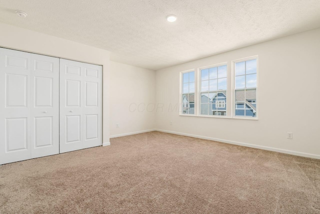 3339 Lauren Fields Dr S, Groveport, OH 43125 - unfurnished bedroom with carpet, baseboards, a textured ceiling, and a closet