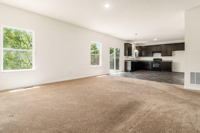 3339 Lauren Fields Dr S, Groveport, OH 43125 - unfurnished living room with carpet, baseboards, a sink, and recessed lighting