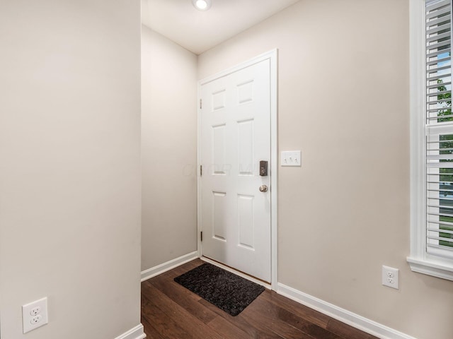 4783 Nieles Edge Dr, Columbus, OH 43232 - doorway to outside featuring baseboards and dark wood-type flooring