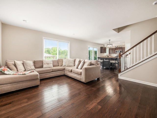 4783 Nieles Edge Dr, Columbus, OH 43232 - living room featuring dark wood-style flooring, a chandelier, and stairs