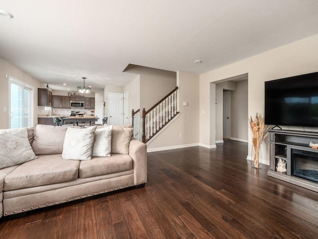 4783 Nieles Edge Dr, Columbus, OH 43232 - living area featuring stairway, wood finished floors, baseboards, a chandelier, and recessed lighting