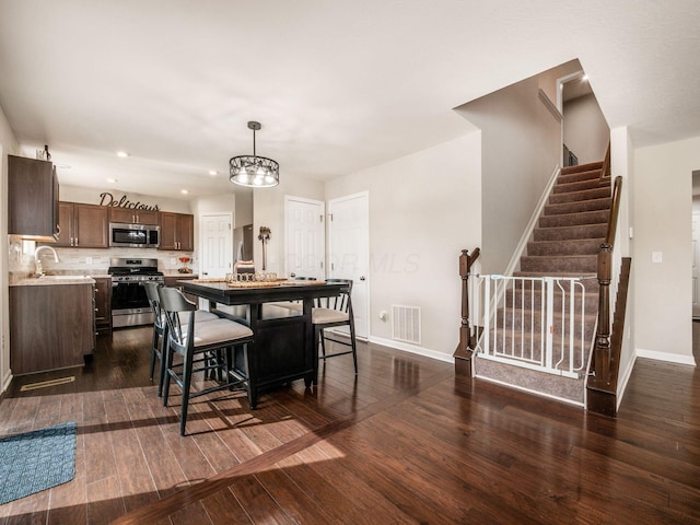 4783 Nieles Edge Dr, Columbus, OH 43232 - dining space with recessed lighting, dark wood finished floors, stairway, and baseboards