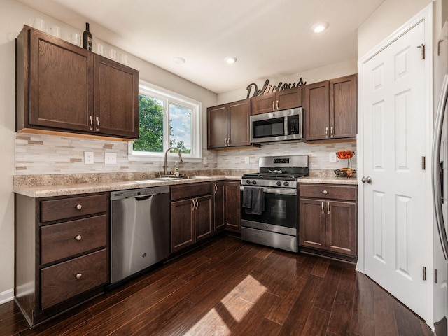 4783 Nieles Edge Dr, Columbus, OH 43232 - kitchen featuring stainless steel appliances, a sink, light countertops, dark brown cabinets, and recessed lighting