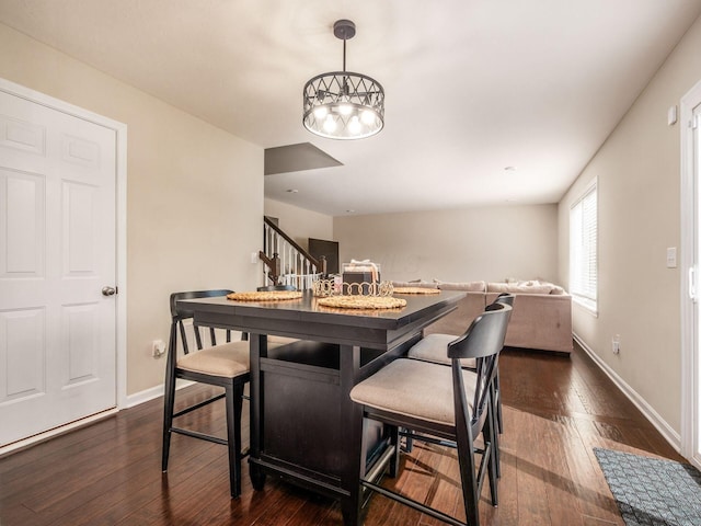 4783 Nieles Edge Dr, Columbus, OH 43232 - dining area featuring dark wood finished floors, stairway, and baseboards