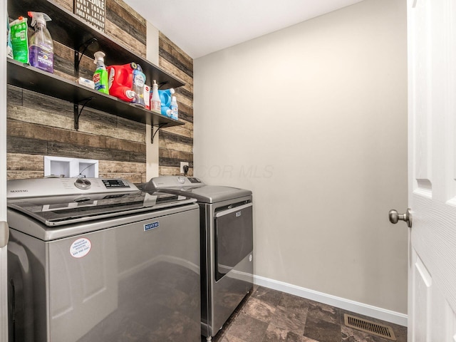 4783 Nieles Edge Dr, Columbus, OH 43232 - laundry room with washer and clothes dryer, baseboards, and dark stone finish flooring