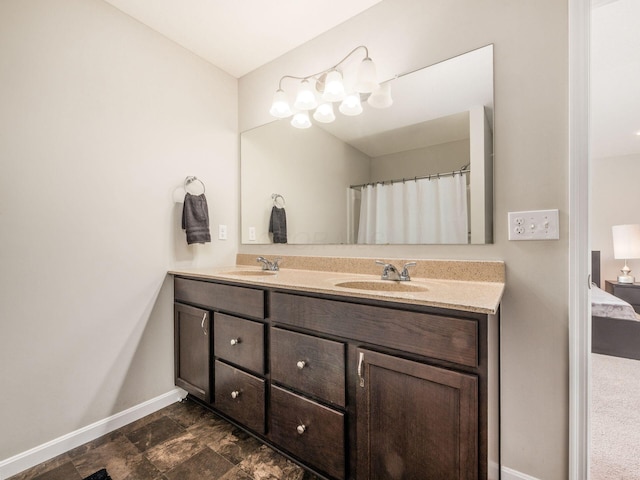 4783 Nieles Edge Dr, Columbus, OH 43232 - bathroom featuring baseboards, double vanity, and ensuite bathroom