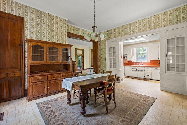 4093 State Route 257, Radnor, OH 43066 - dining room with wallpapered walls, a chandelier, brick patterned floors, and ornamental molding