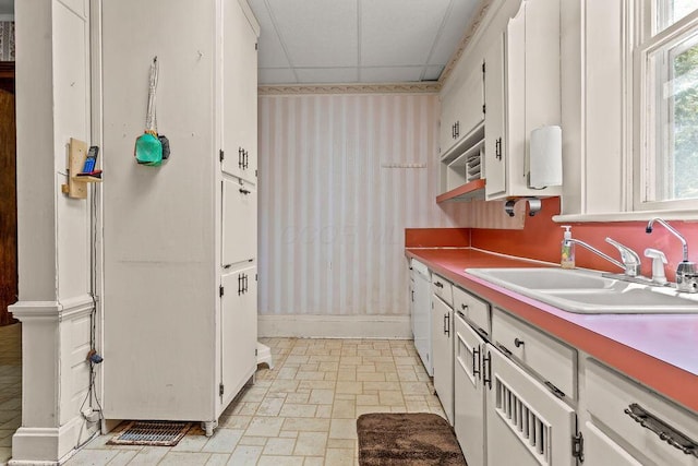 4093 State Route 257, Radnor, OH 43066 - kitchen with a drop ceiling, wallpapered walls, and white cabinetry
