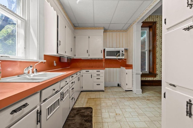 4093 State Route 257, Radnor, OH 43066 - kitchen featuring a drop ceiling, wallpapered walls, white cabinets, and light countertops