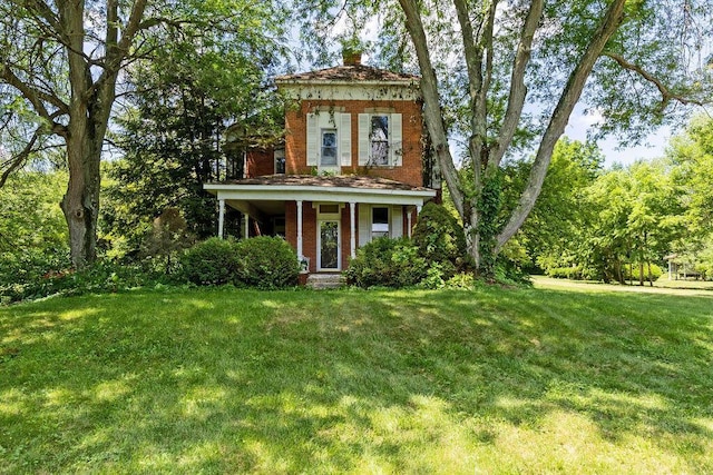 4093 State Route 257, Radnor, OH 43066 - italianate house featuring a front lawn, brick siding, and a chimney