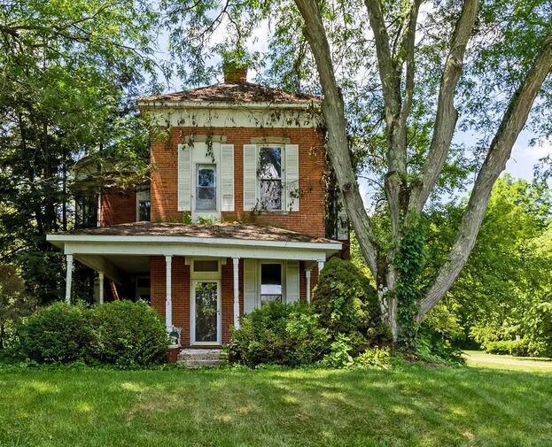 4093 State Route 257, Radnor, OH 43066 - view of front of house featuring a front yard, brick siding, and a chimney