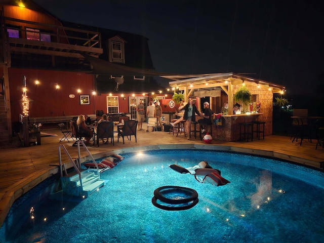 2309 N Houston Pike, South Vienna, OH 45369 - pool at night featuring a wooden deck and an outdoor pool